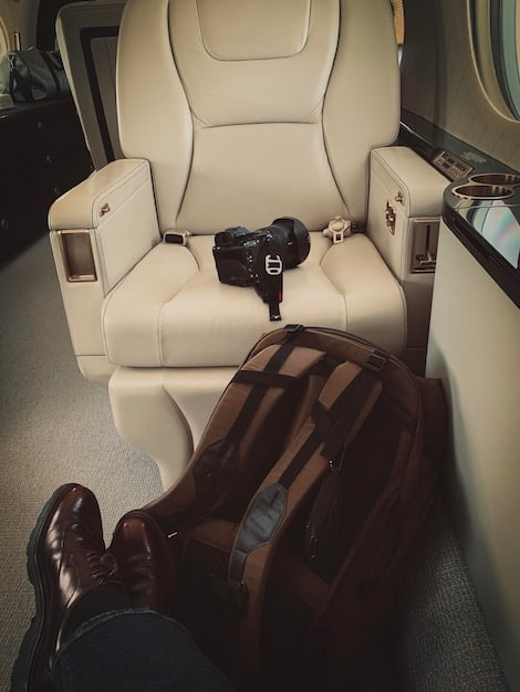 A luxurious airplane interior featuring spacious seating, mood lighting, and premium amenities; the image conveys comfort and exclusivity, emphasizing the rewards of upgrading with airline miles.