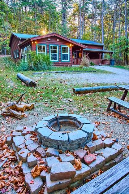 A scenic view of a cozy cabin nestled in the woods, suggesting a comfortable and relaxing accommodation option for a road trip.