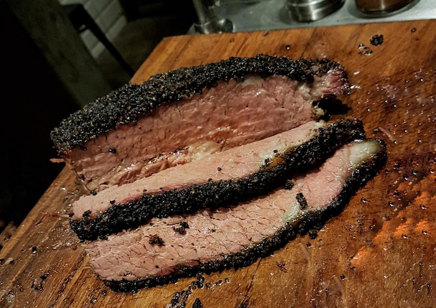 A mouthwatering shot of a smoker filled with Texas brisket, showing the rich, dark bark and tender, juicy meat.