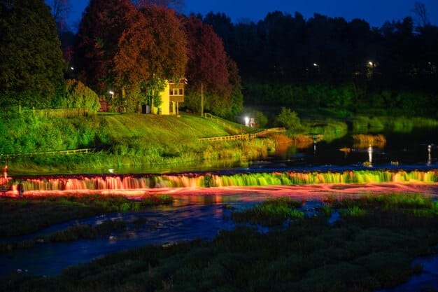 A beautifully captured night view of Strawberry Park Hot Springs, with lanterns illuminating the pools and surrounding trees. The image conveys a sense of magic and tranquility.
