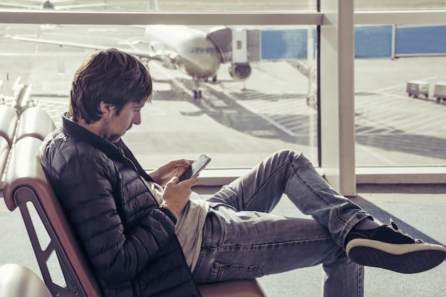 A person sitting at an airport gate, smiling and relaxed, while viewing airport restaurant reviews and gate information on the GateGuru app.