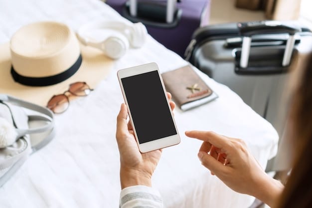 A portable travel router placed on a table in a hotel room, with a smartphone and a laptop connected to its Wi-Fi network, illustrating the convenience of sharing internet access among multiple devices.