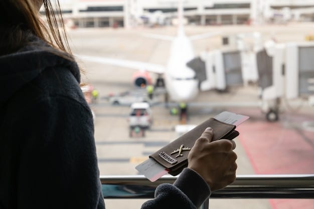 A close-up shot of a student holding a smartphone displaying a flight booking app with discounted fares, against the backdrop of an airport terminal.