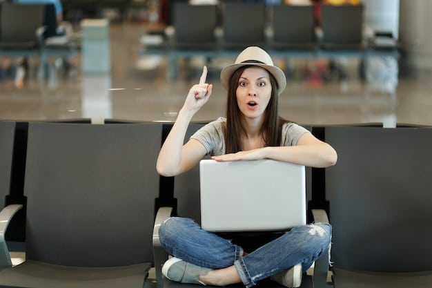 A person enthusiastically pointing at a laptop screen showing a travel booking website with prominently displayed flash sale banners and discount percentages. The background is blurred to focus on the laptop and the person's excitement.
