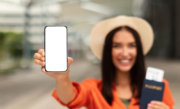 A person holding an airline credit card and a smartphone displaying an airline loyalty program's app. Focus on the details of the card and the app's interface, showing the accumulation of airline miles.