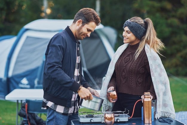 A couple cooking a meal on a portable camping stove near their campsite in a national park. Focus on the 
