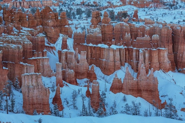 A snowy landscape in Bryce Canyon National Park, Utah, with the iconic hoodoos covered in a layer of white. The image captures the serene beauty of the park in winter, offering a unique perspective on the Southwest's natural wonders. This image exemplifies to adventure to the Southwest when Is a 5-Day US Southwest Adventure Right for You?.