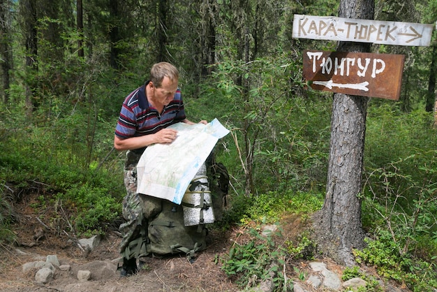 A ranger posting a sign about trail closures due to bear activity in Yellowstone National Park. The image illustrates the importance of checking park alerts and conditions to avoid unexpected disruptions and ensure safety. This highlights how you can Avoid These 5 Common Mistakes When Planning Your US National Parks Itinerary.