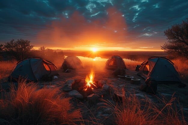 A vibrant sunset over a campsite in a national park, with tents pitched and a campfire burning under a starlit sky, conveying peaceful budget travel.