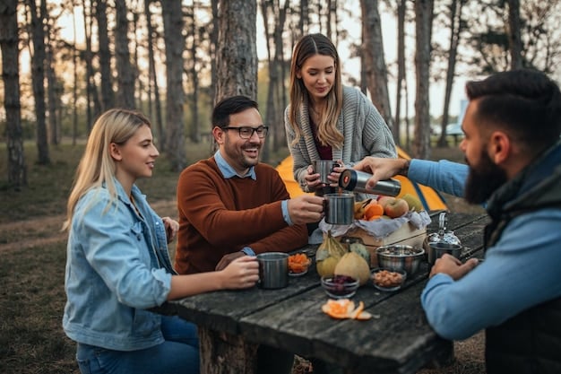 A group of friends sharing a meal cooked over a small portable camp stove in a scenic national park campsite, emphasizing budget-friendly food preparation.