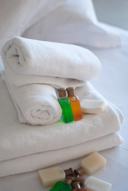 A pile of clean, folded towels and a selection of miniature toiletries on a hotel bathroom counter, symbolizing the typical amenities provided by housekeeping that guests might forgo when using the 'Do Not Disturb' sign.The focus is on cleanliness and abundance. Could be related to Unlock Secret Hotel Perks: The 'Do Not Disturb' Hack That Saves You Money.