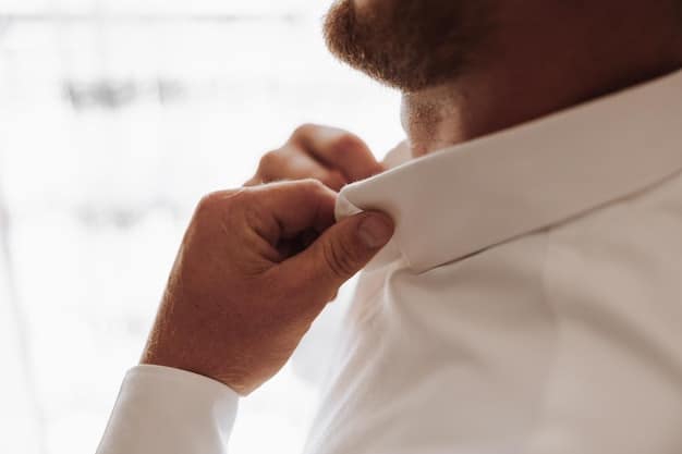 A close-up shot of a person carefully folding a dress shirt, highlighting the crisp lines and neat presentation. Focus on the hands and the fabric texture, with a soft, diffused light that emphasizes detail. The image should convey precision and care in the folding process, related to the 'Pack Like a Pro: The Rolling vs. Folding Debate (and Which One Saves Space)'.