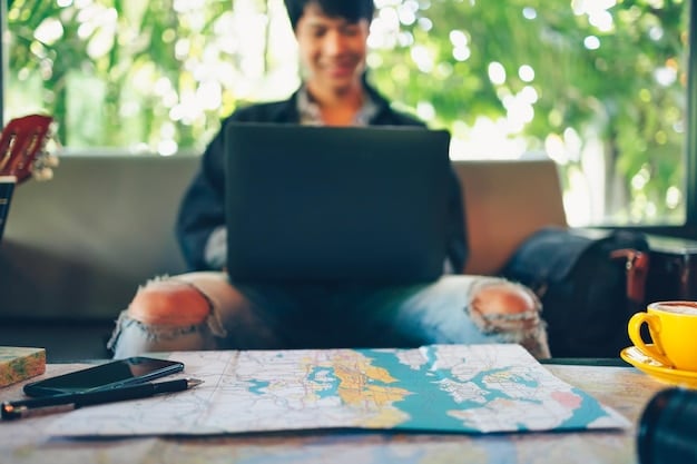 A person sitting at a desk with a laptop, surrounded by travel brochures and maps. They are smiling and pointing at the laptop screen, which displays a travel booking website with Cyber Monday deals.