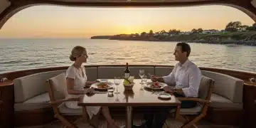 Couple enjoying luxury yacht dining at sunset, U.S. coast