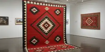 Navajo rug with traditional patterns in a modern gallery, showcasing Indigenous American craft.